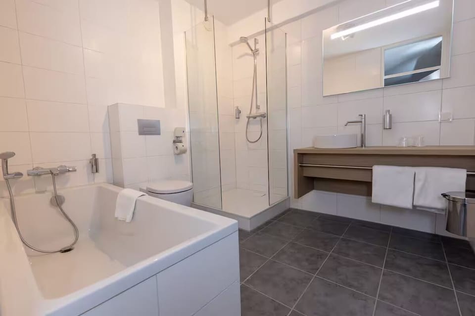 Unwind with a rainfall shower, deep tub, and crisp towels.