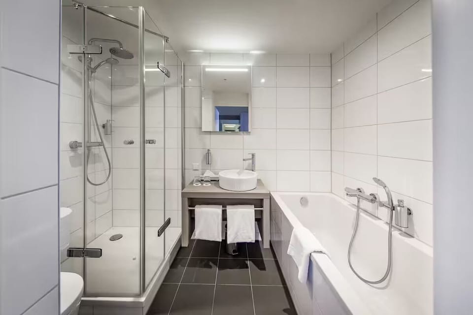 Refresh easily in a spotless bath with glass shower and tub.