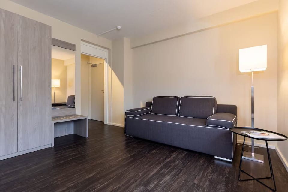 Unwind on the plush sofa in a bright, spacious suite