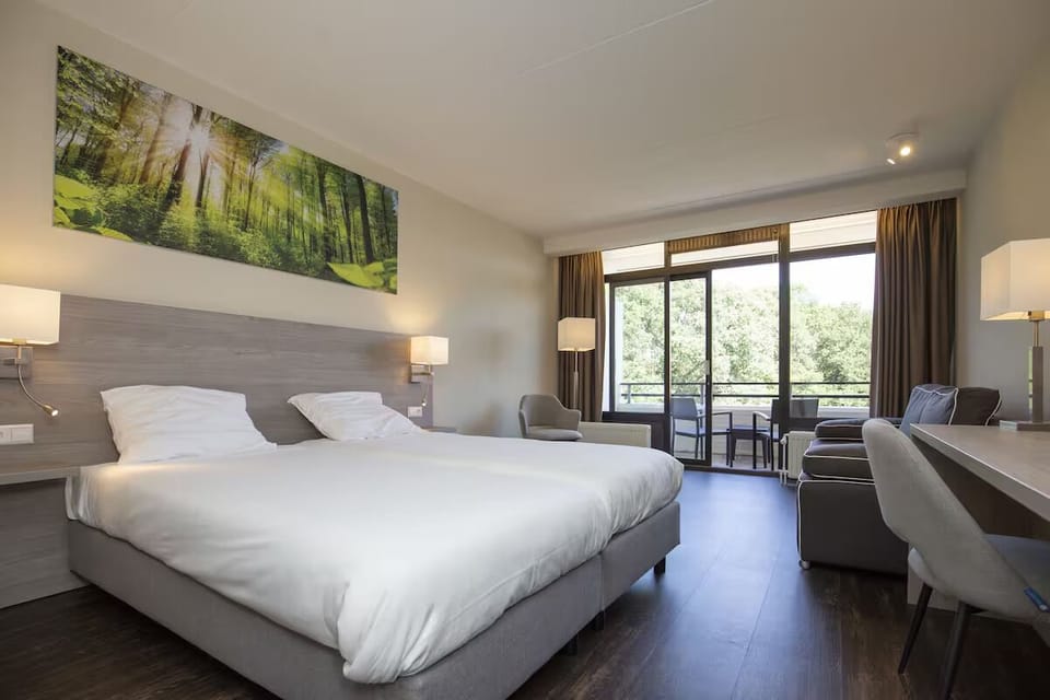 Relax in a spacious, sunlit room with cozy seating.