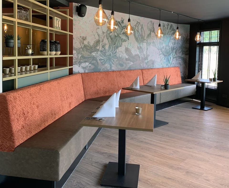 Settle into plush booth seating for long, cozy dinners.
