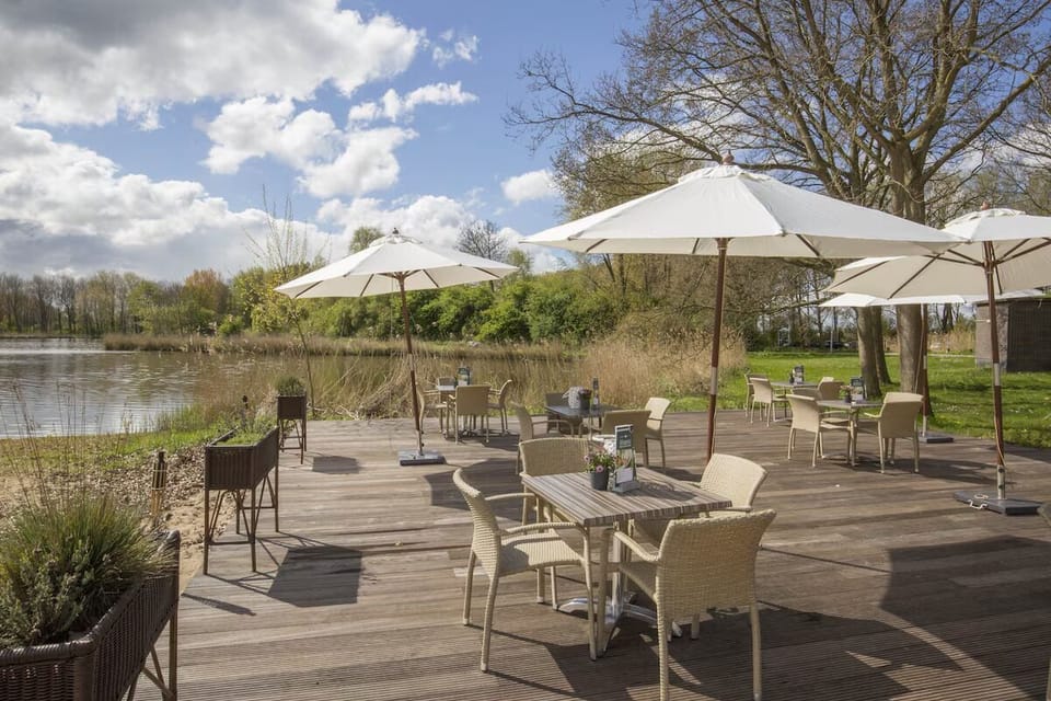 Sip morning coffee on the lakeside deck under umbrellas.