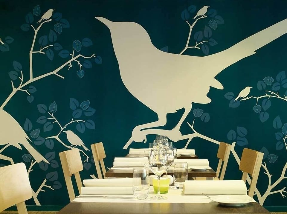 Gather for memorable meals beside bold, artful statement walls.