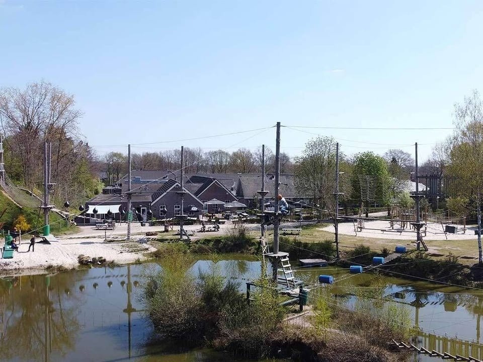 Picture yourself tackling thrilling ropes courses above tranquil water.