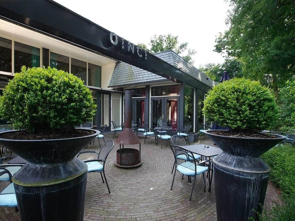 Sip morning coffee outdoors in a peaceful courtyard setting.