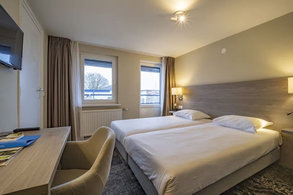 Stretch out comfortably in twin beds with soft evening light.
