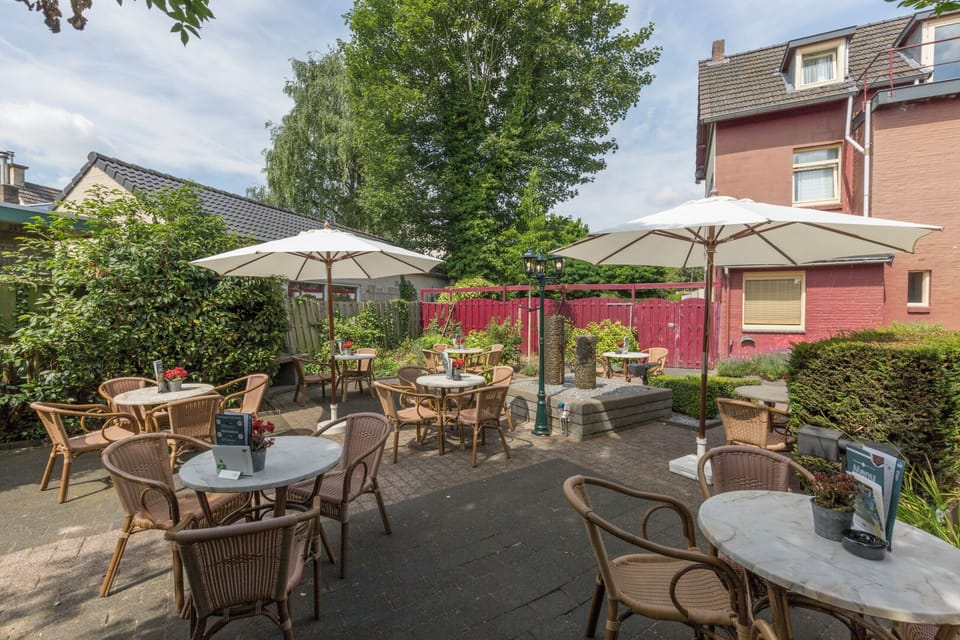 Soak up sunshine on the charming terrace with umbrellas.