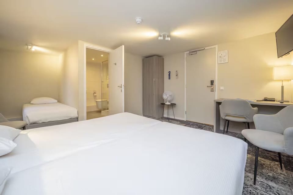 Unwind in a bright room with bed and workspace.