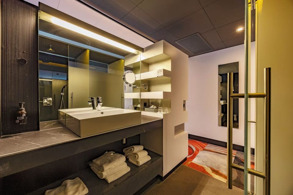 Refresh effortlessly at the sleek vanity with plush towels.