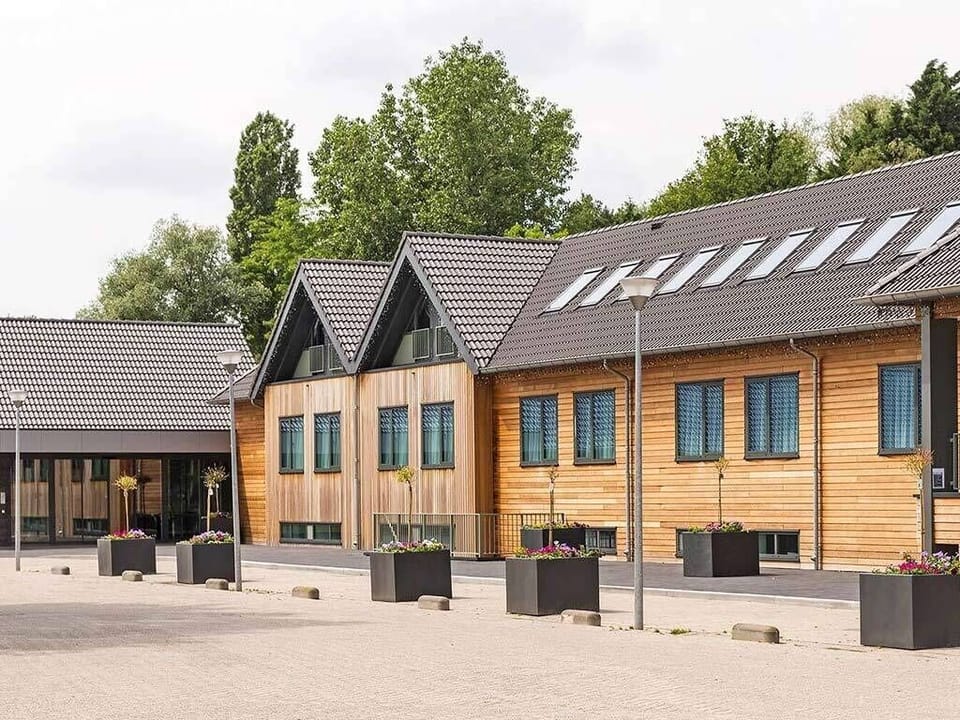 Arrive to warm timber architecture and a calm courtyard welcome.