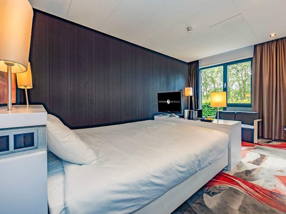 Sink into plush bedding and gaze out at calming greenery.