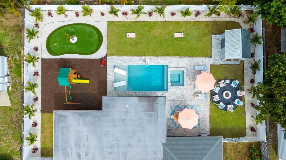 Your own private backyard retreat—pool and spa, putting green, fire pit, bar with swing seating, outdoor dining, and plenty of space for everyone to relax, play, and make memories together.