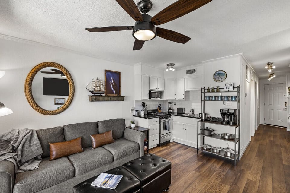 Open-concept living and kitchen at Me Time, We Time | Casa del Mar 214—modern boho beach design with a cozy lounge and fully equipped space to unwind.