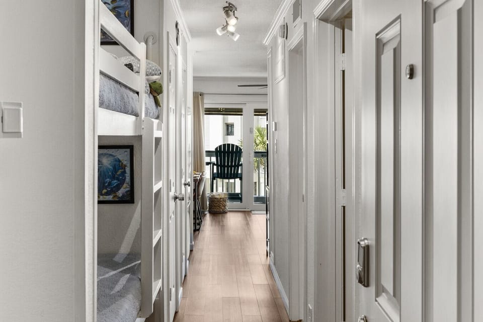 Bright entry at Me Time, We Time | Casa del Mar 214 with built-in bunks and a straight path to balcony views and the beach beyond.