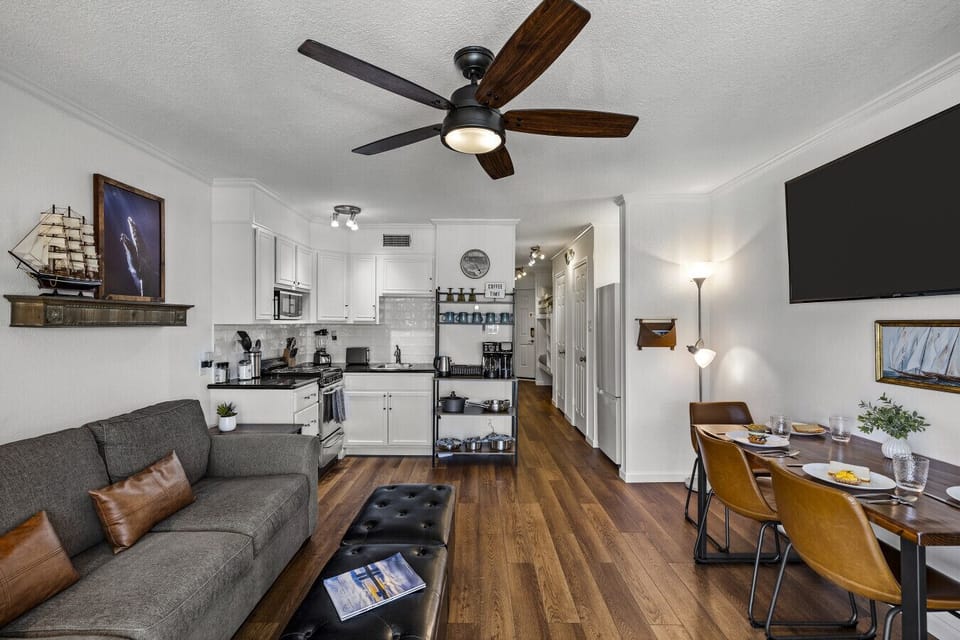 Open-concept living, dining, and kitchen at Me Time, We Time | Casa del Mar 214—remodeled with modern boho style and designed for relaxing stays.