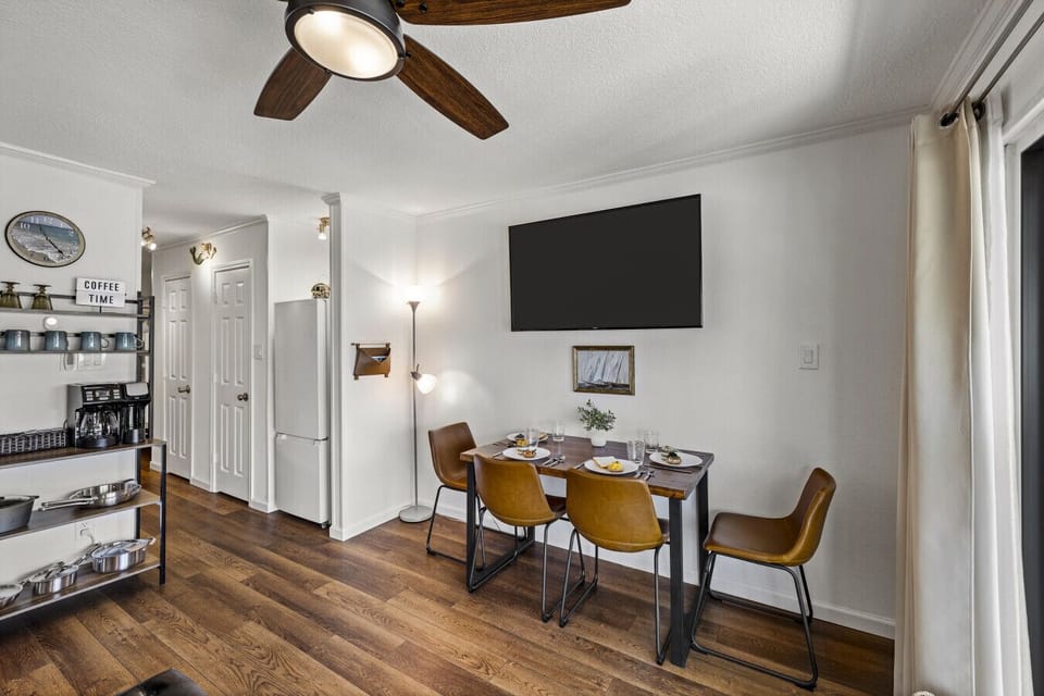 Dining area at Me Time, We Time | Casa del Mar 214 with a large smart TV—perfect for meals, games, or unwinding after the beach.