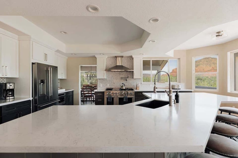 Your gourmet kitchen features stunning quartz countertops, premium appliances, and breathtaking mountain views through expansive windows.