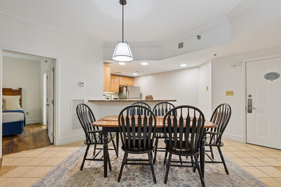 Gather around this charming dining table where your group can share memorable meals together in this bright, open space.