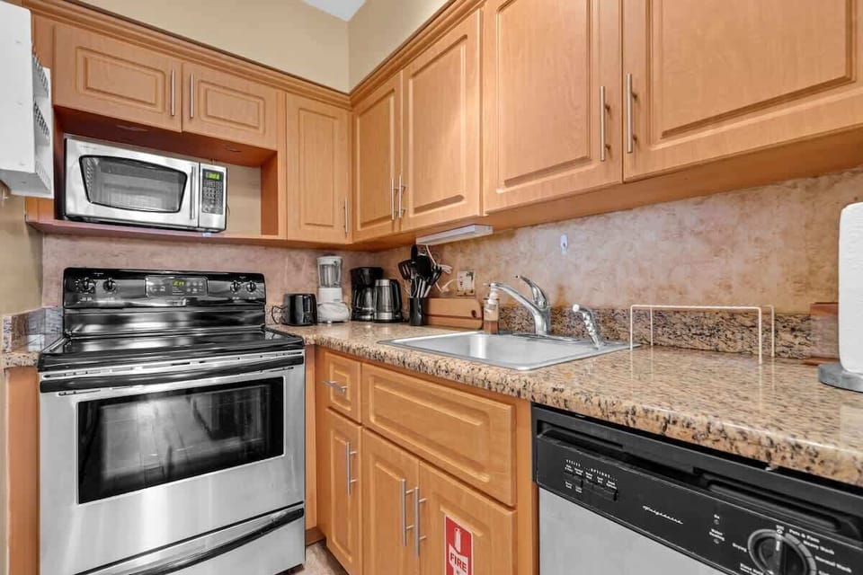 Cook with ease in this fully equipped kitchen featuring sleek granite countertops, modern stainless-steel appliances, and ample cabinet space. Everything you need for a comfortable beach stay is right at your fingertips!