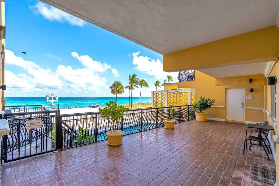 Step onto the shared oceanfront balcony and soak in unobstructed views of the Atlantic. Palm trees, turquoise water, and direct beach access — all just outside your door.