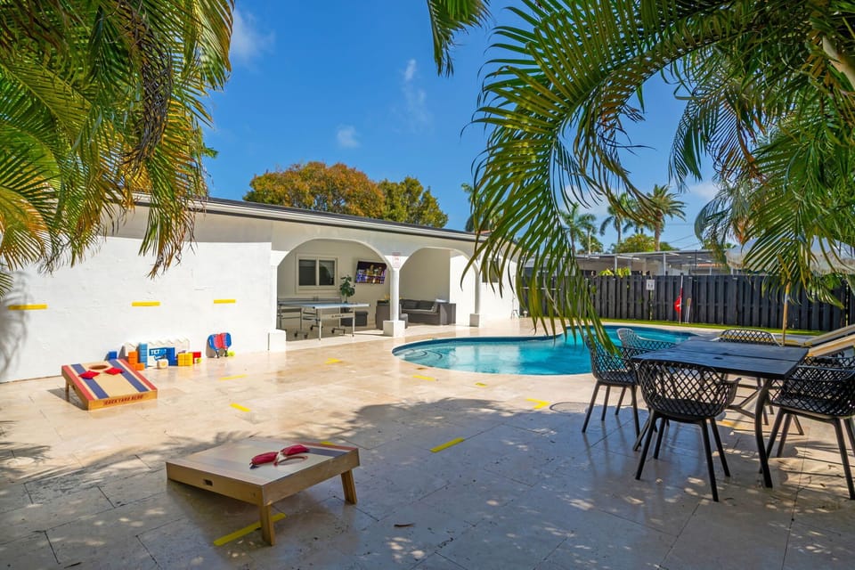 The ultimate outdoor playground! Enjoy cornhole, ping pong, a sparkling pool, outdoor dining, and a covered patio with TV — all surrounded by swaying palms. Fun never stops here! 