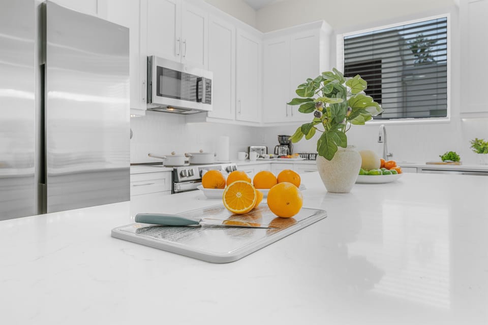 Modern kitchen island with fresh accents and ample prep space—perfect for cooking, serving, and gathering.