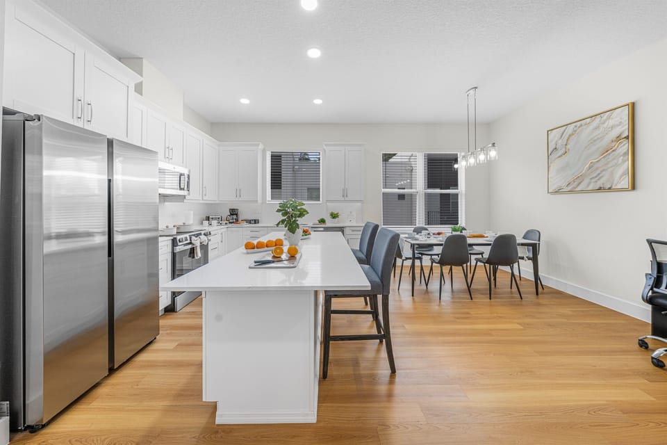 The oversized kitchen island doubles as a breakfast bar with seating for two — perfect for quick bites or morning coffee chats.