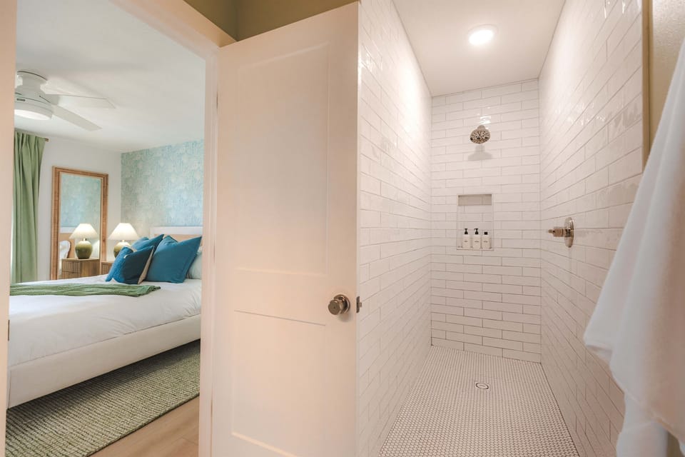 The en suite bath with spacious walk-in shower includes Public Goods eco-lux shampoo, conditioner, and body wash for an in-home spa experience.