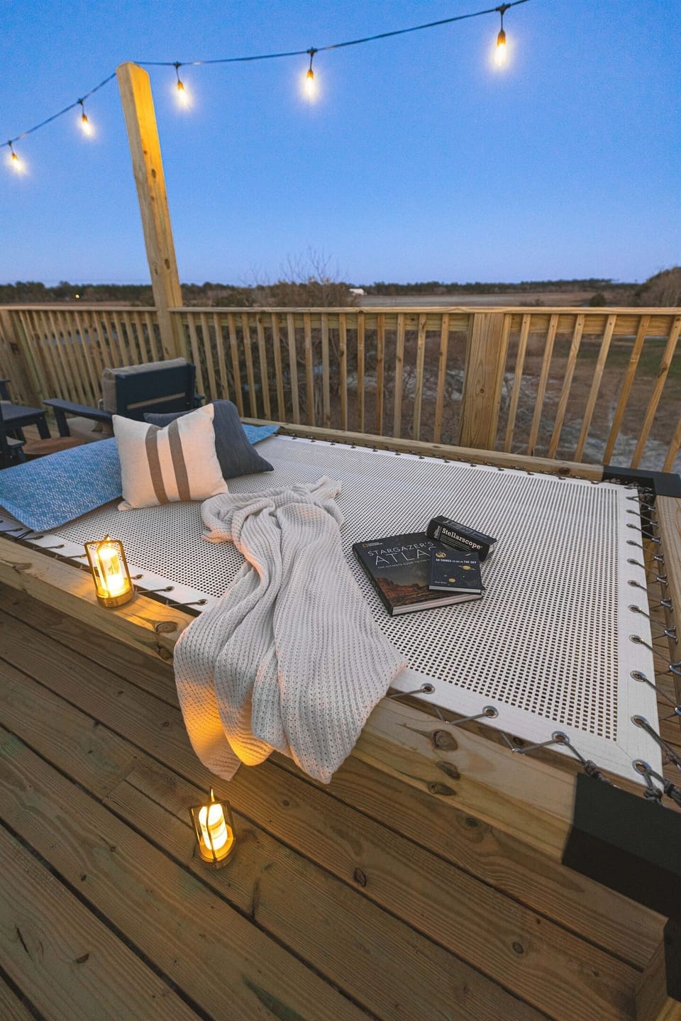 An elevated custom stargazer daybed net designed for stretching out, reading, or watching the stars glow. We provide a stellarscope and stargazing books, making this a favorite spot for quiet moments during the day and star-filled nights after dark.
