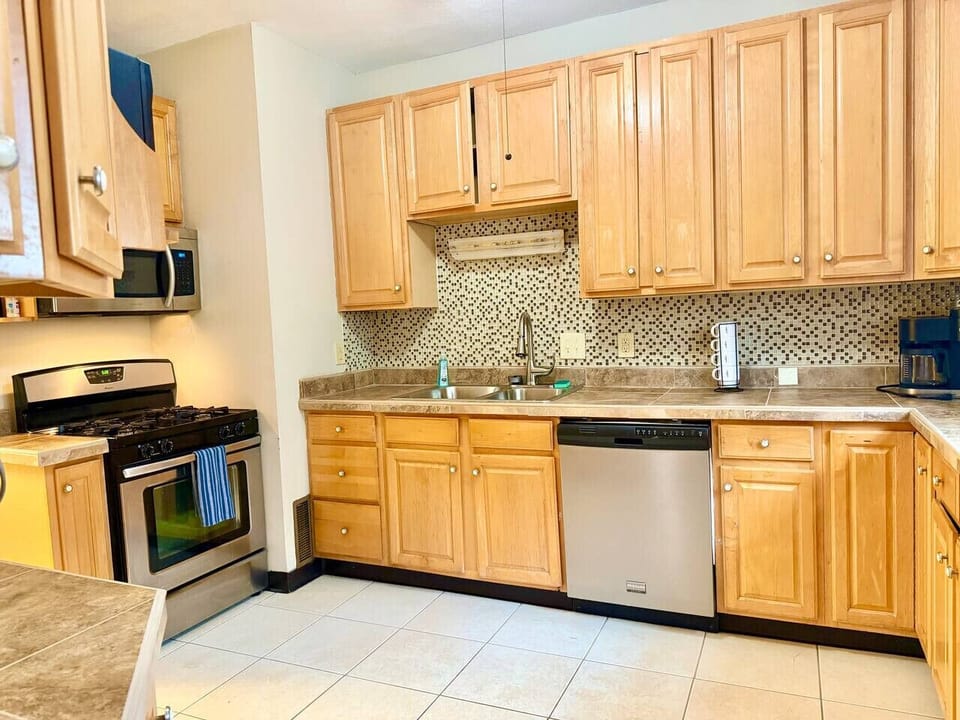 Bright, functional kitchen with ample counter space and cabinetry for storage. Features modern appliances and a practical layout, making it easy to cook, gather, and enjoy everyday meals.