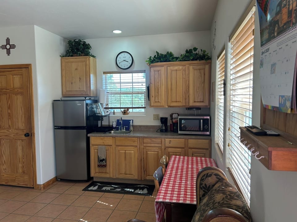 Open-concept view from the front door showcasing the dining nook & kitchenette.
