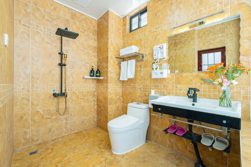 Family Triple Room, Courtyard View | Bathroom | Shower, free toiletries, hair dryer, slippers