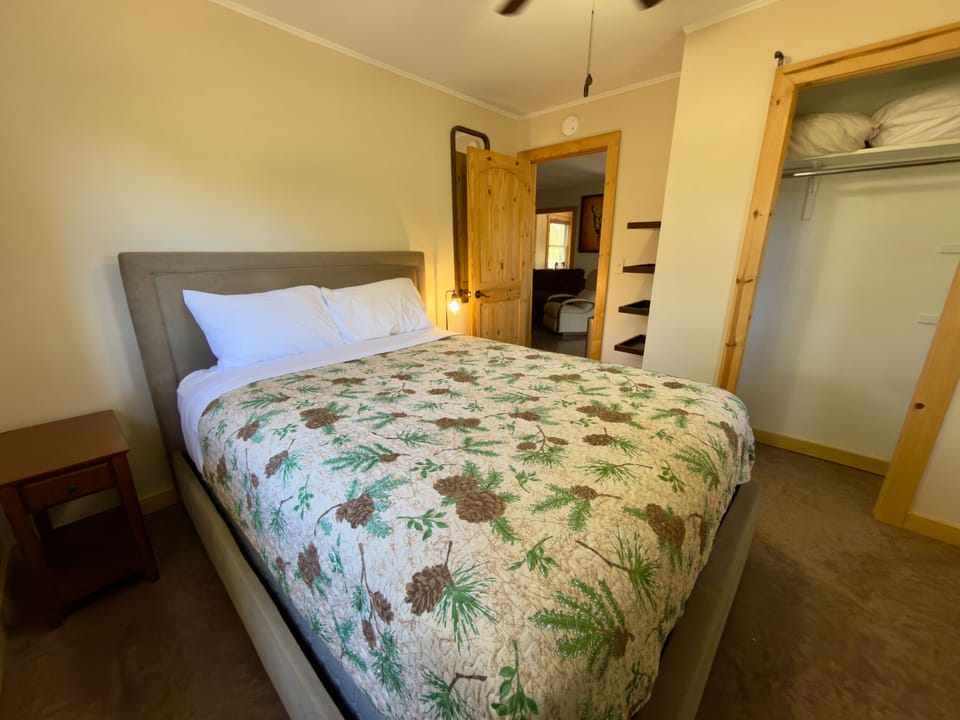 Cozy bedroom with comfy bed, open closet, and warm rustic touches