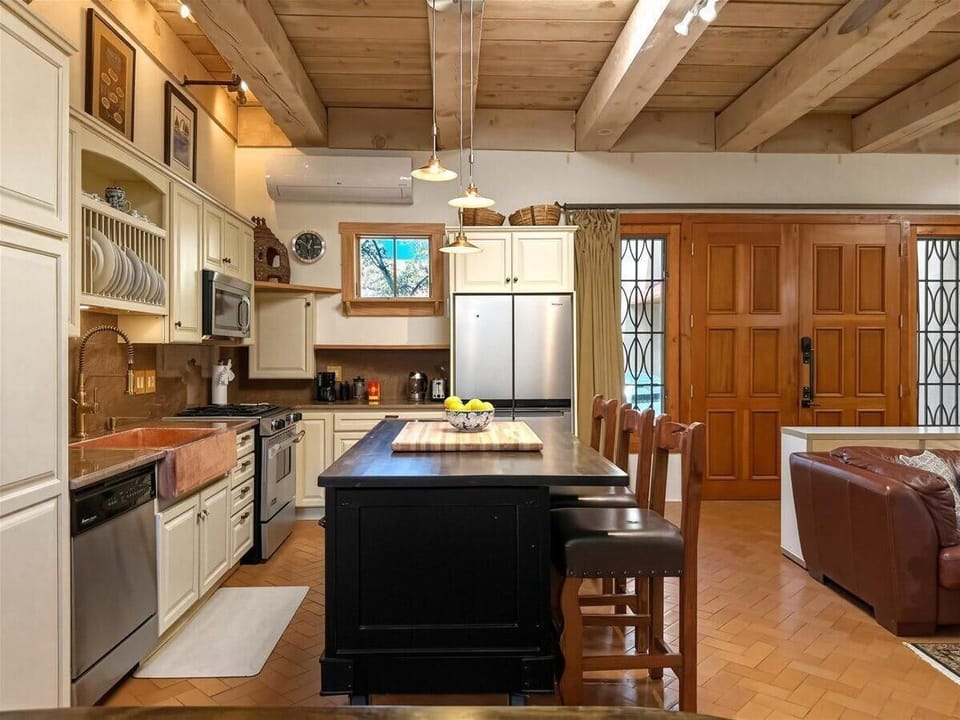 Thoughtfully designed with modern appliances, a farmhouse-style sink, and island seating—perfect for both everyday meals and relaxed entertaining.