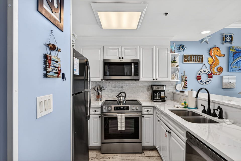 The recently updated, fully equipped kitchen features quartz countertops, stainless-steel appliances, and has everything you need to prepare meals for family & friends.