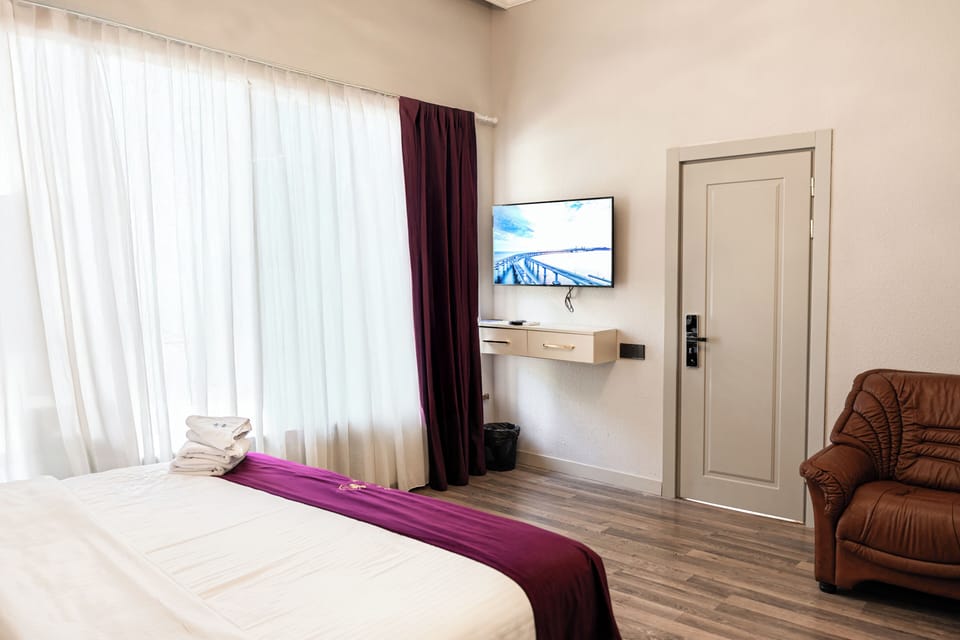 Deluxe Double Room, Balcony, Courtyard View | In-room safe, blackout drapes, soundproofing, iron/ironing board