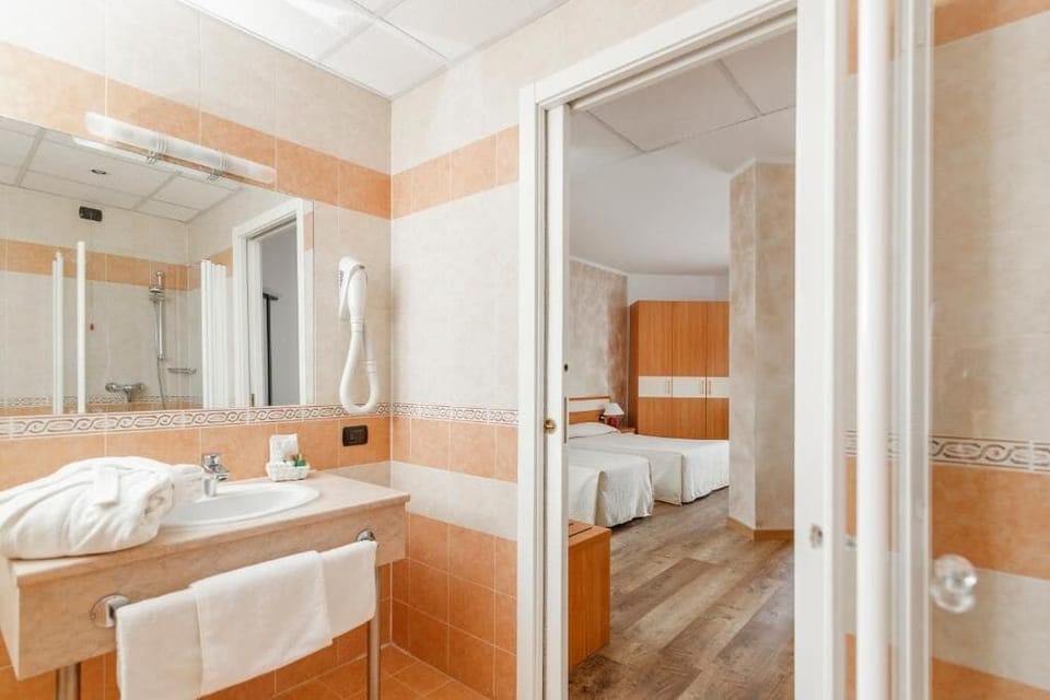 Standard Triple Room, Balcony | Bathroom | Shower, hair dryer, slippers, towels