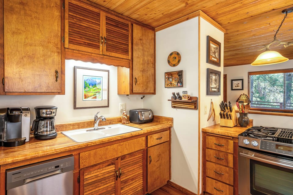 Your fully equipped kitchen features warm wood cabinets, modern appliances, and thoughtful touches that make cooking feel like home.