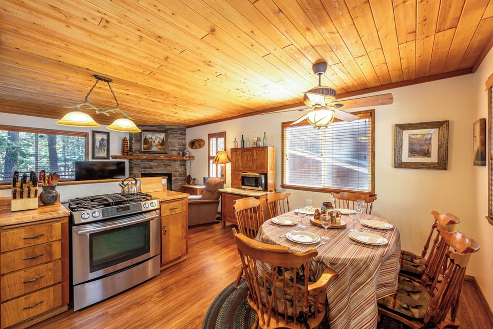 Your cozy cabin kitchen welcomes you with warm wood details and rustic charm for memorable meals together.