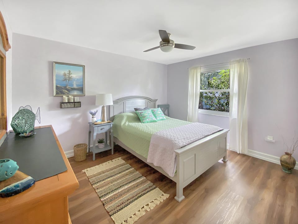 Serene bedroom with garden views and soft, natural light.