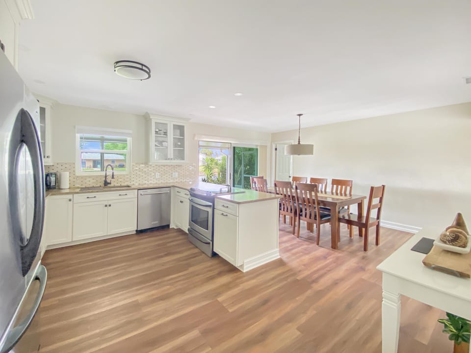 Spacious kitchen and dining area with modern appliances and natural light.