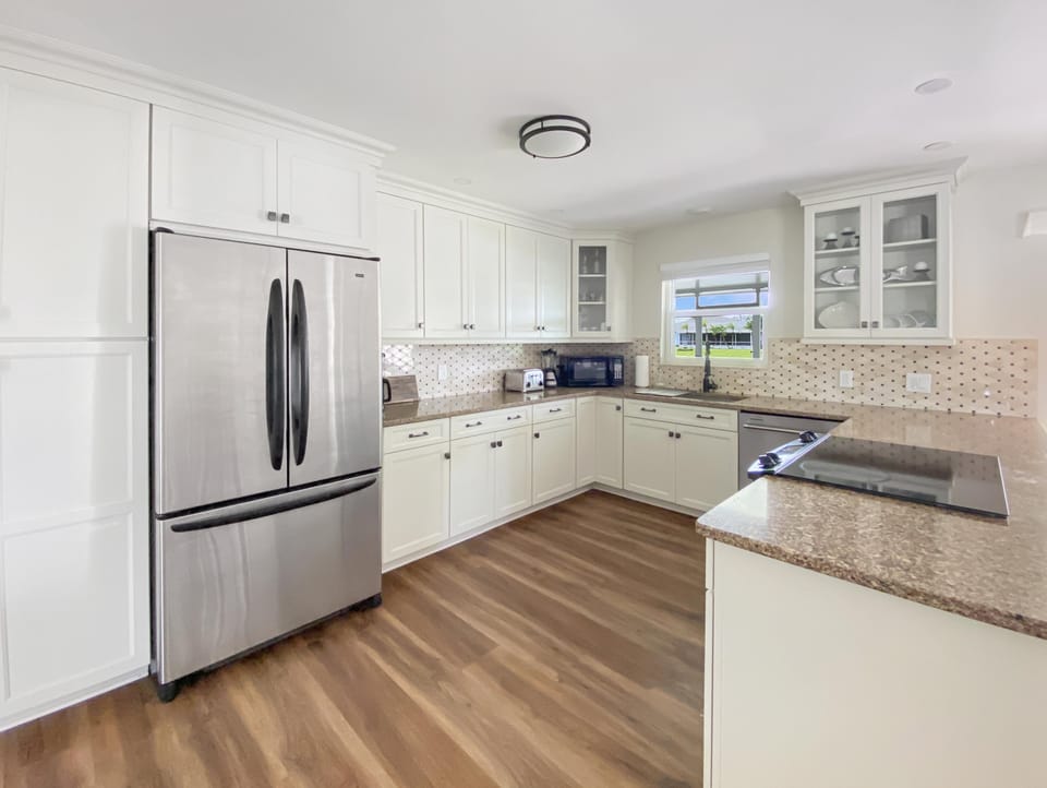 Modern kitchen with stainless steel appliances and ample counter space for cooking.