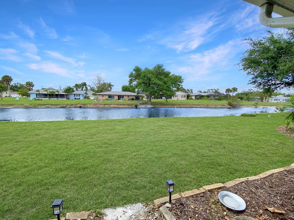 Serene backyard with tranquil river views, perfect for relaxation and outdoor activities.
