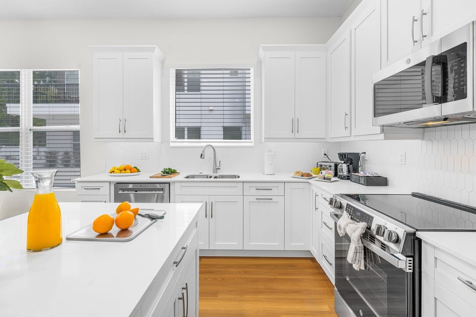 Modern kitchen with sleek white cabinetry, large island, and plenty of prep space.