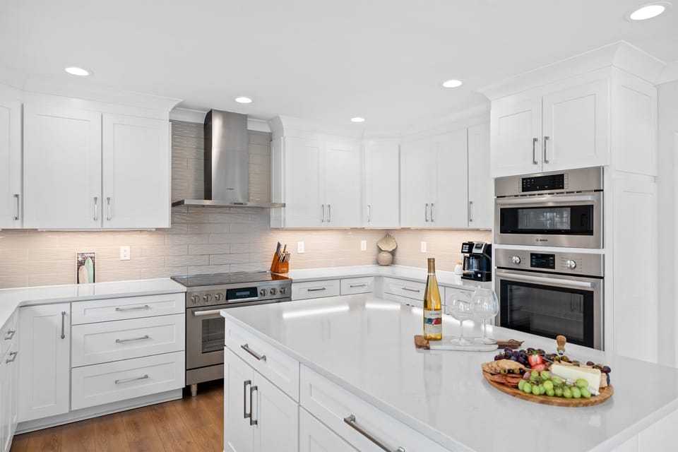 Stunning chef’s kitchen with sleek white finishes, premium appliances, and an oversized island for gathering
