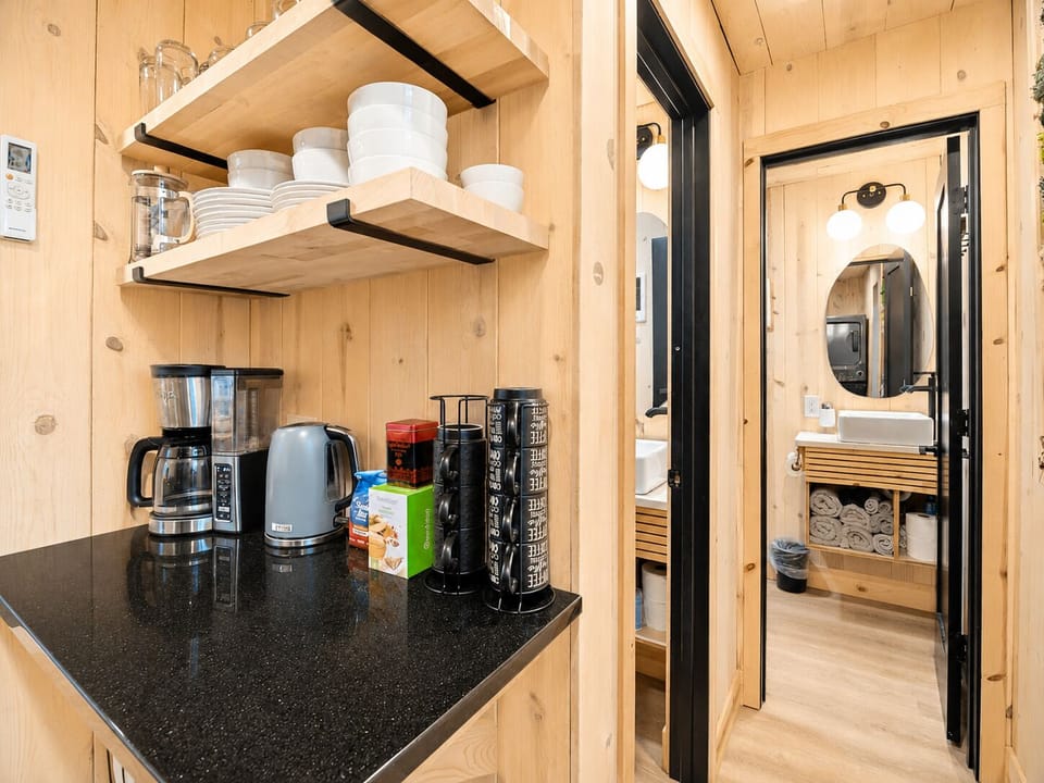 Coffee bar with drip machine, kettle, and tea for early mornings.