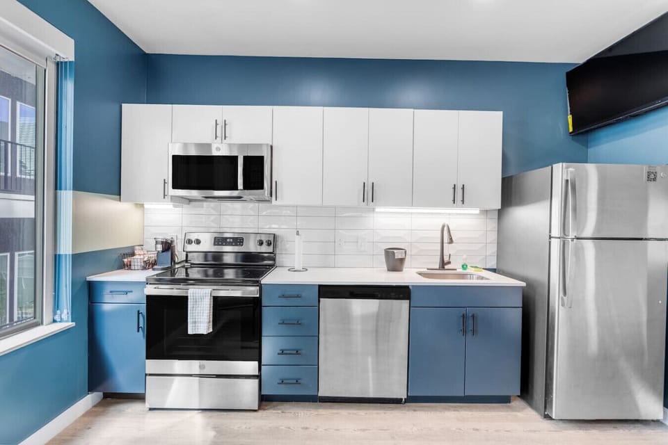 Modern kitchen with sleek stainless steel appliances.