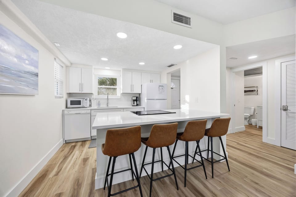 Open kitchen with bar seating and modern appliances