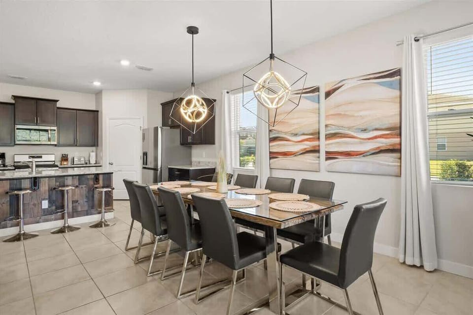 Spacious dining area with seating for everyone, right next to the kitchen for easy serving. Bright and inviting, perfect for sharing meals and making memories together.