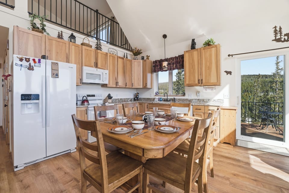 Fully stocked with dishes, kitchen gadgets, and cooking accessories, brand new appliances, and offers comfortable seating for 6 around the dining table.